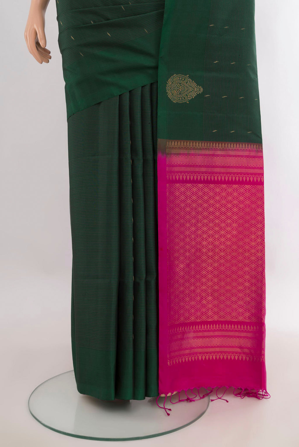 Pleats and pallu of Pure Silk Bottle Green Soft Saree with Zari Butta on the body and Without Border. 