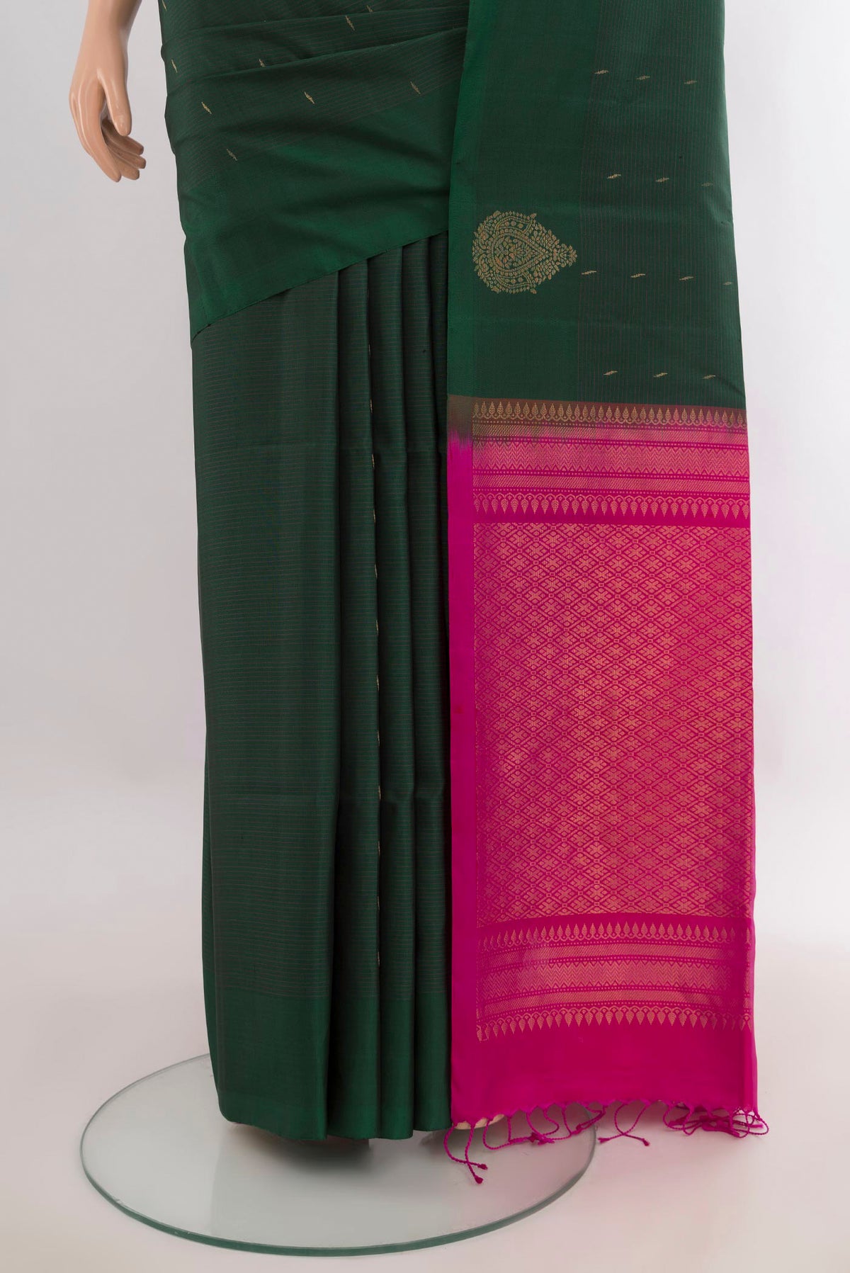 Pleats and pallu of Pure Silk Bottle Green Soft Saree with Zari Butta on the body and Without Border. 