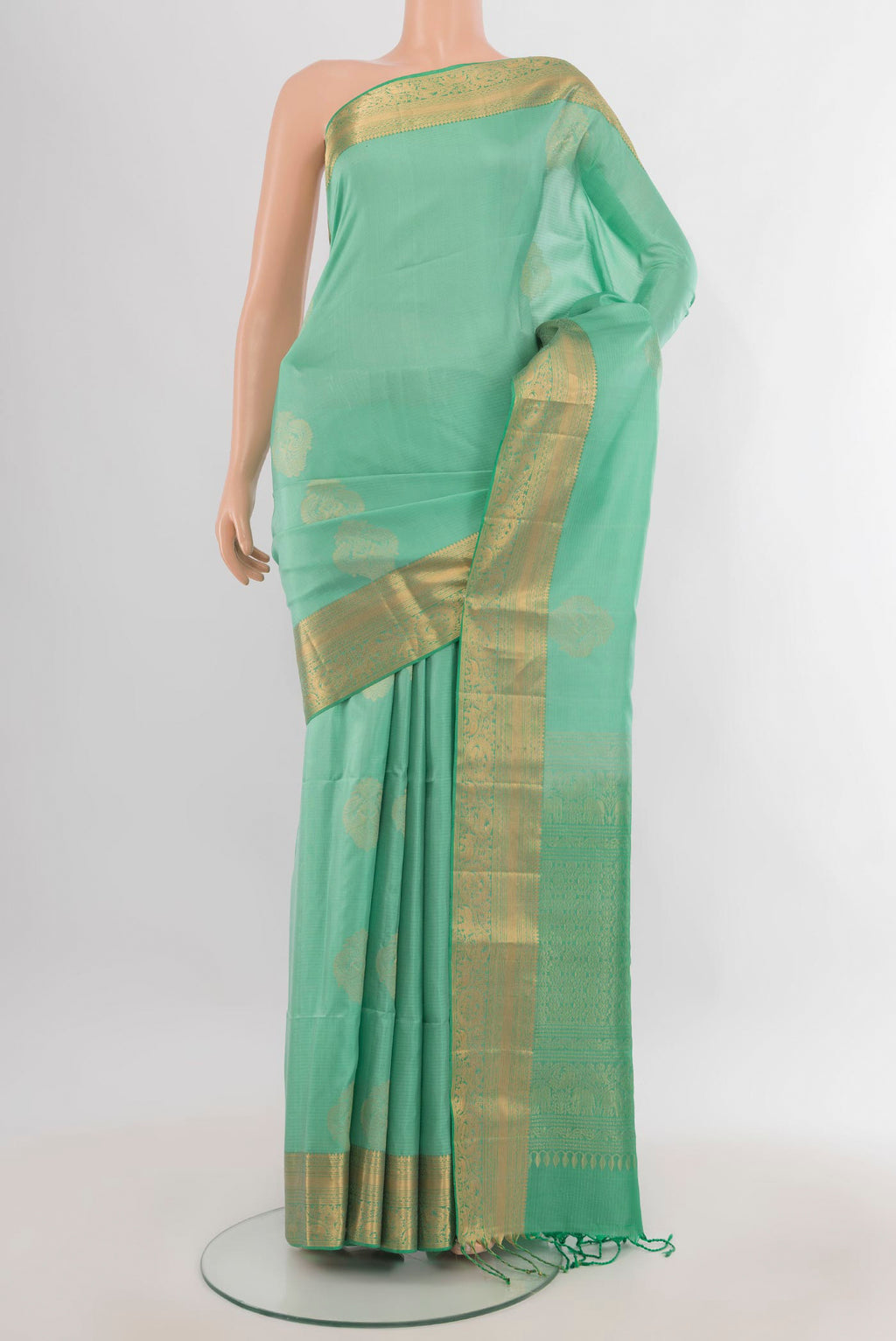 Pure Silk Mint Green Soft Saree with Zari Butta on the body and Zari Border.  displayed on a mannequin