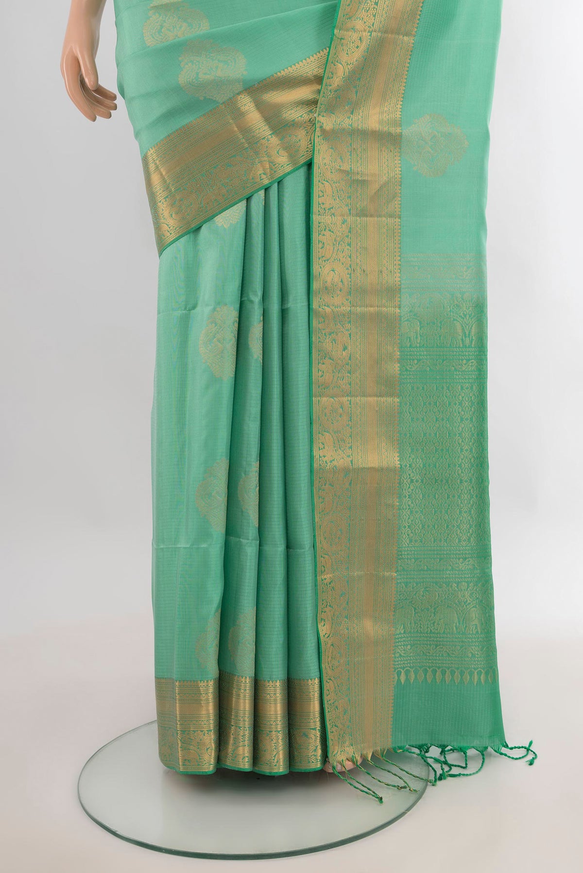Pleats and pallu of Pure Silk Mint Green Soft Saree with Zari Butta on the body and Zari Border. 