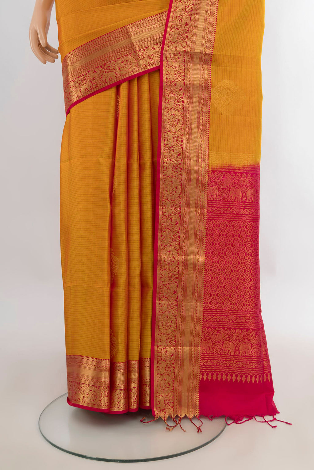 Pleats and pallu of Pure Silk Mustard Soft Saree with Zari Butta on the body and Zari Border. 