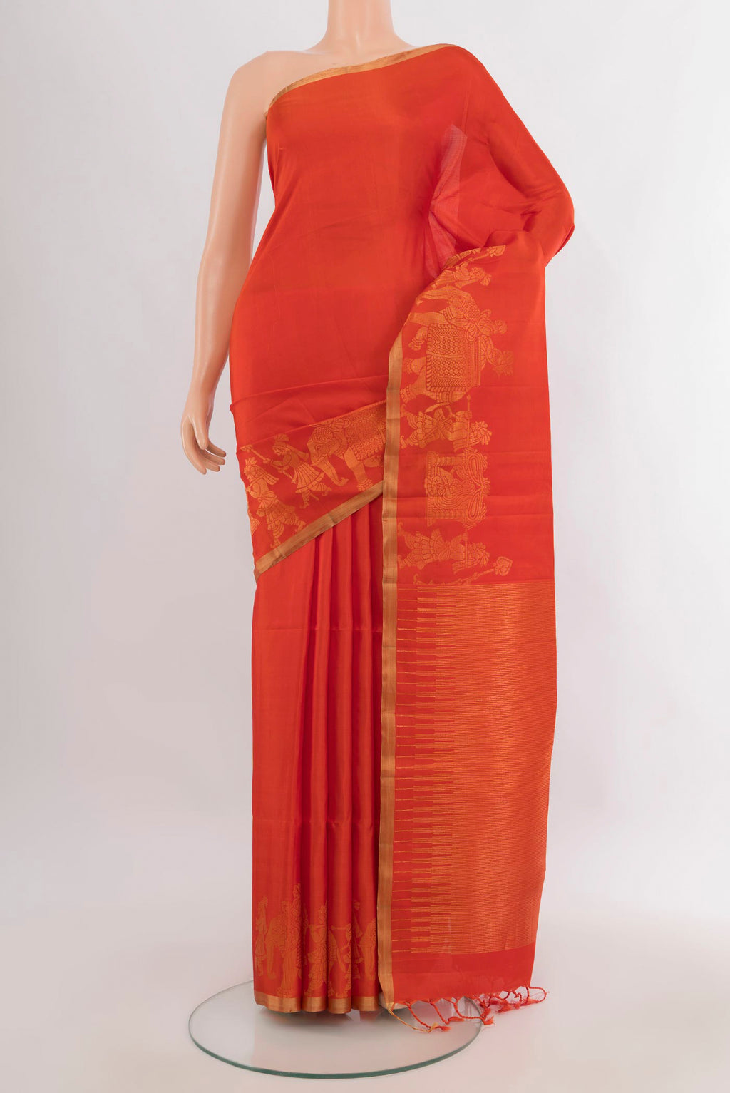 Pure Silk Orange Soft Saree with Plain Body and Zari Border.  displayed on a mannequin