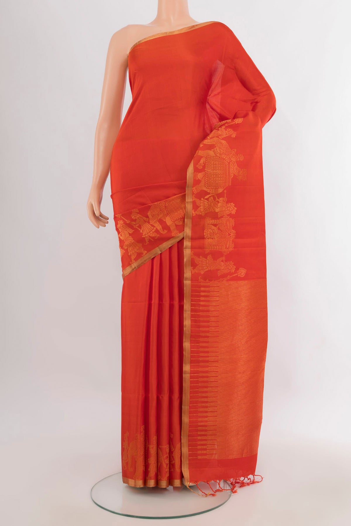 Pure Silk Orange Soft Saree with Plain Body and Zari Border.  displayed on a mannequin