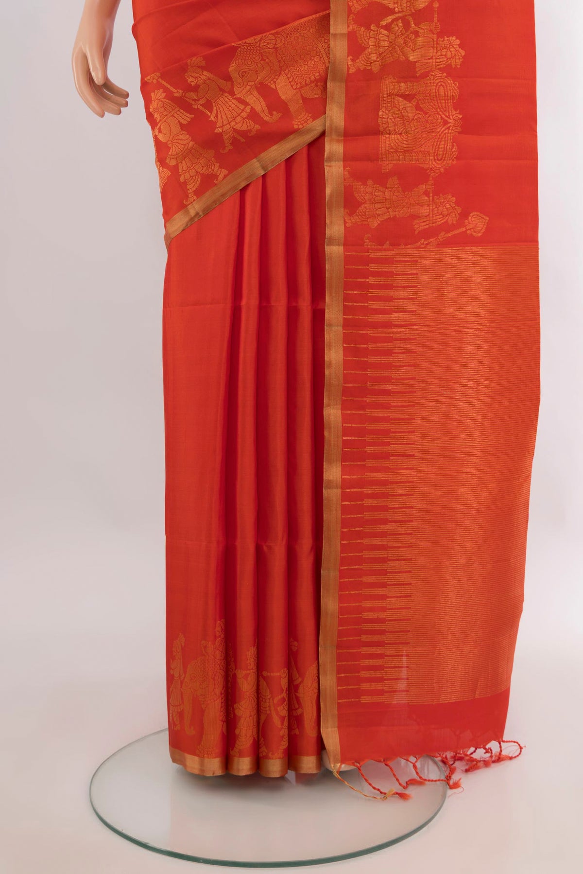 Pleats and pallu of Pure Silk Orange Soft Saree with Plain Body and Zari Border. 