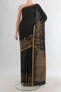 Pure Silk Black Soft Saree with Plain Body and Fancy Border.  displayed on a mannequin