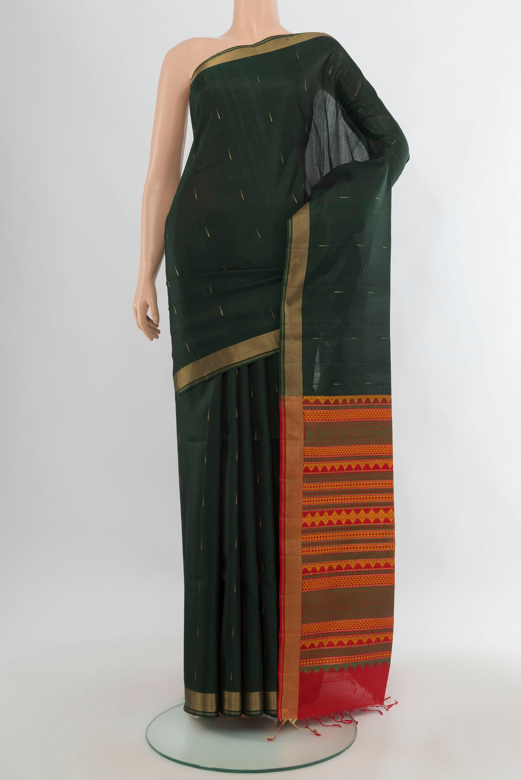Pure Silk Bottle Green Soft Saree with Zari Butta on the body and Zari Border.  displayed on a mannequin