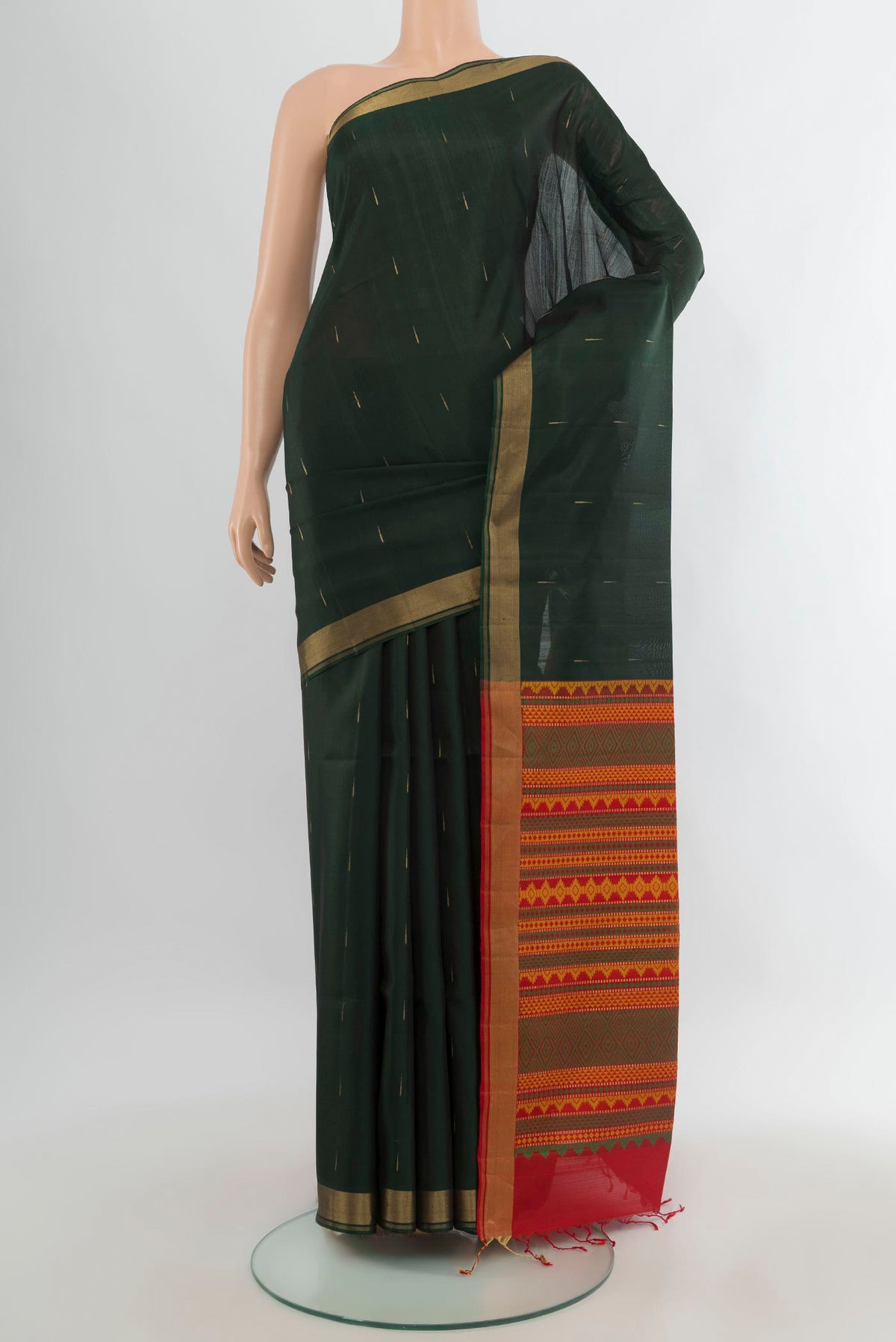 Pure Silk Bottle Green Soft Saree with Zari Butta on the body and Zari Border.  displayed on a mannequin