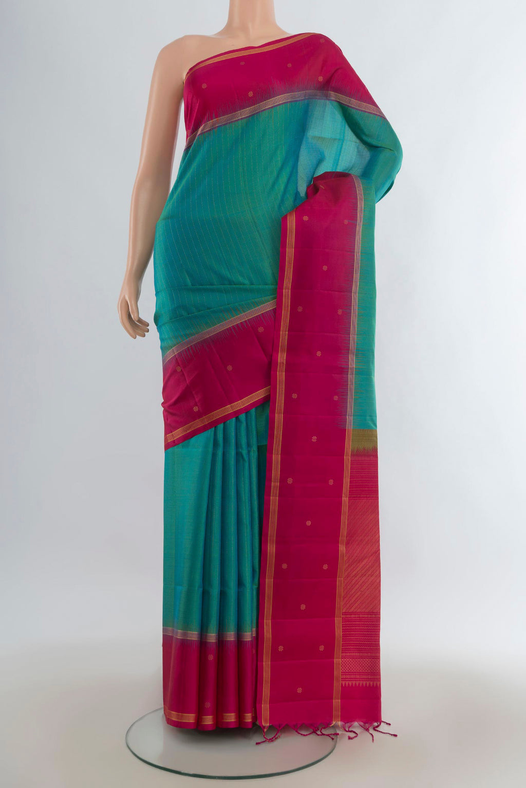 Pure Silk Turquoise Soft Saree with Zari Butta on the body and Plain Border.  displayed on a mannequin