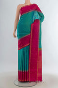 Pure Silk Turquoise Soft Saree with Zari Butta on the body and Plain Border.  displayed on a mannequin