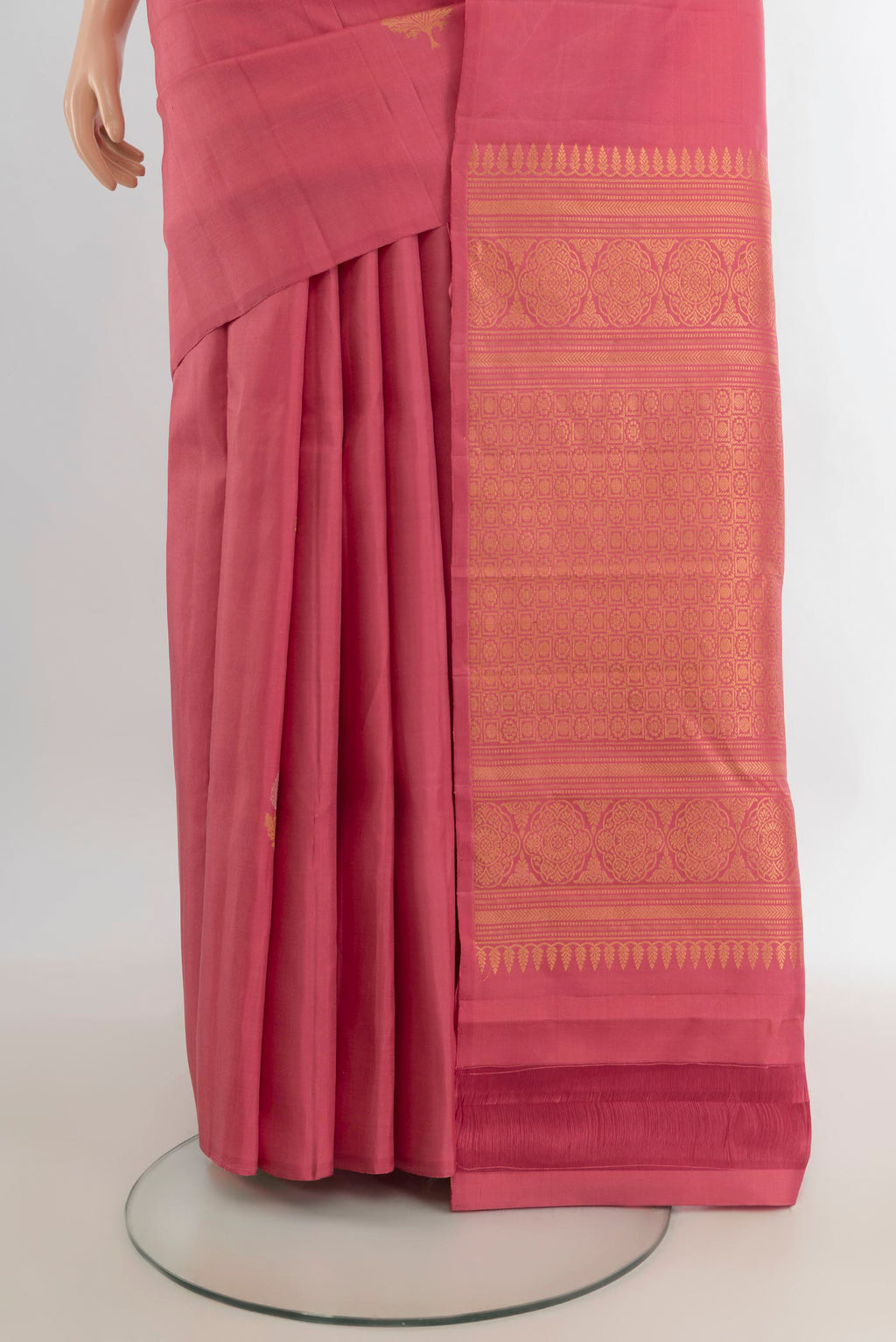 Pleats and pallu of Pure Silk Coral Soft Saree with Zari Butta on the body and Without Border. 