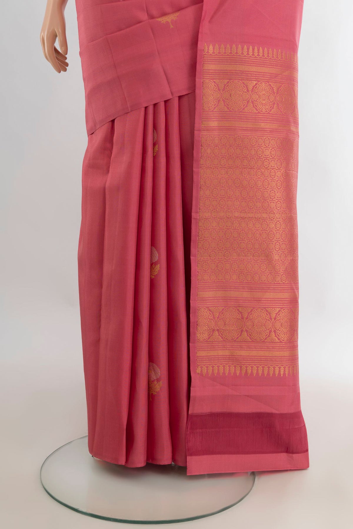 Pleats and pallu of Pure Silk Coral Soft Saree with Zari Butta on the body and Without Border. 