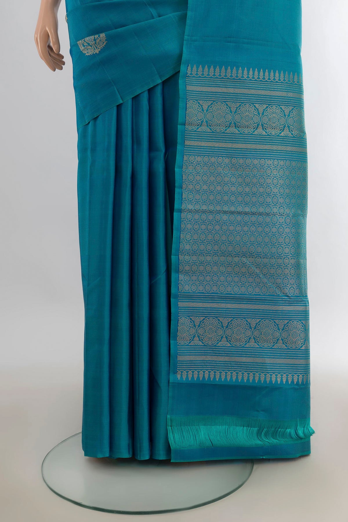 Pleats and pallu of Pure Silk Peacock Blue Soft Saree with Zari Butta on the body and Without Border. 