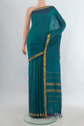 Pure Silk Peacock Blue Kanjivaram Saree with Plain Body and Zari Border.  displayed on a mannequin