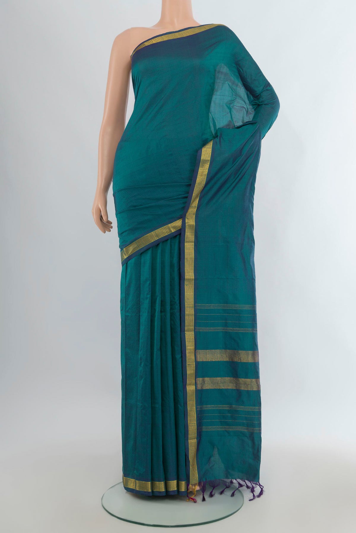 Pure Silk Peacock Blue Kanjivaram Saree with Plain Body and Zari Border.  displayed on a mannequin