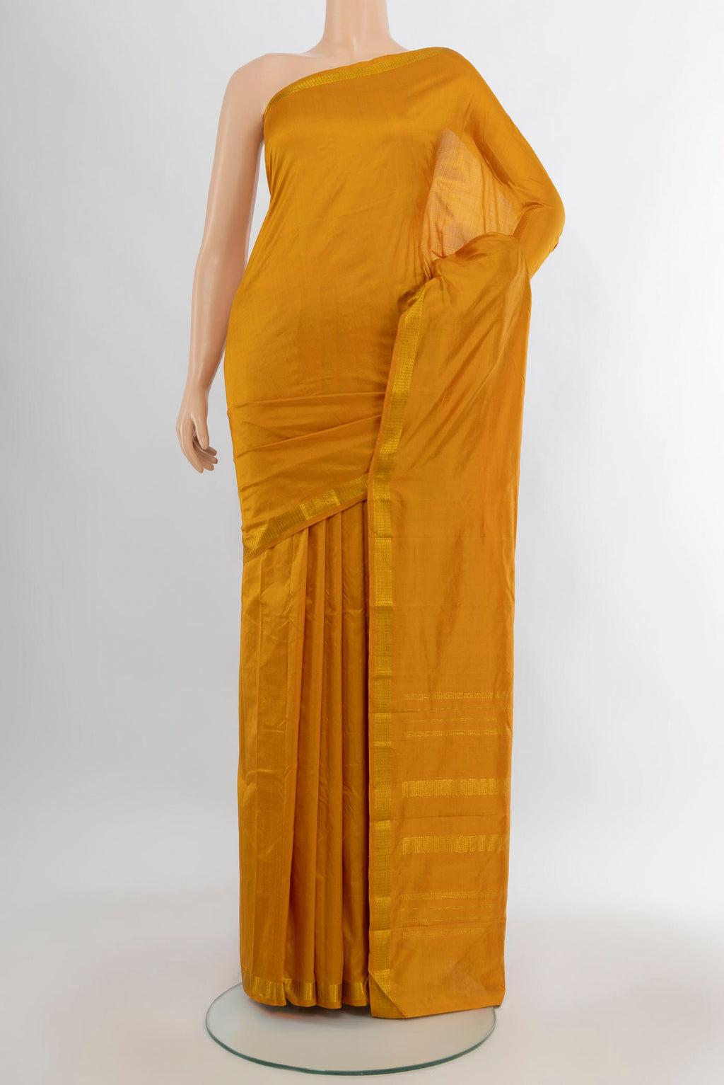 Pure Silk Mustard Kanchipuram Saree with Plain Body and Zari Border.  displayed on a mannequin