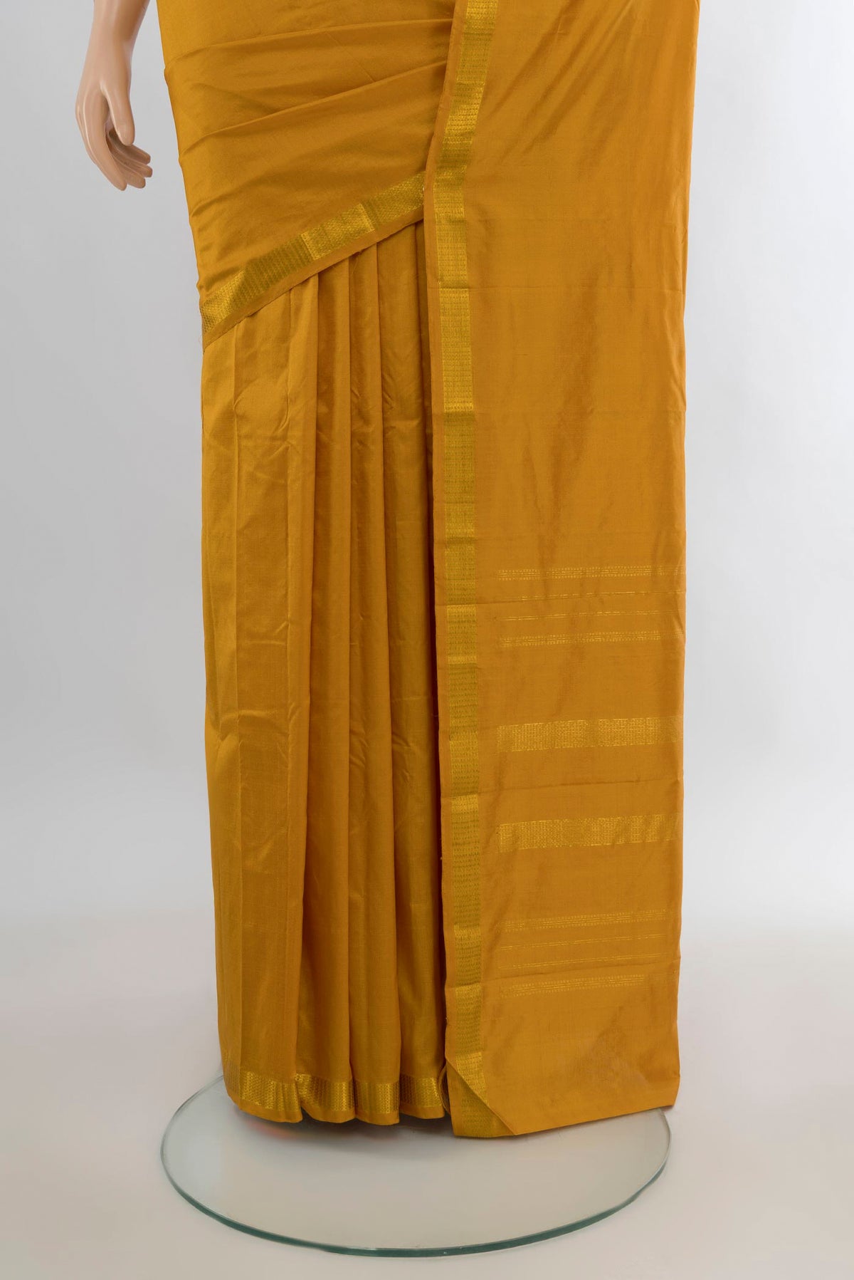 Pleats and pallu of Pure Silk Mustard Kanchipuram Saree with Plain Body and Zari Border. 