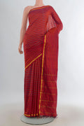 Pure Silk Brick Orange Kanchipuram Saree with Stripes on the body and Zari Border.  displayed on a mannequin