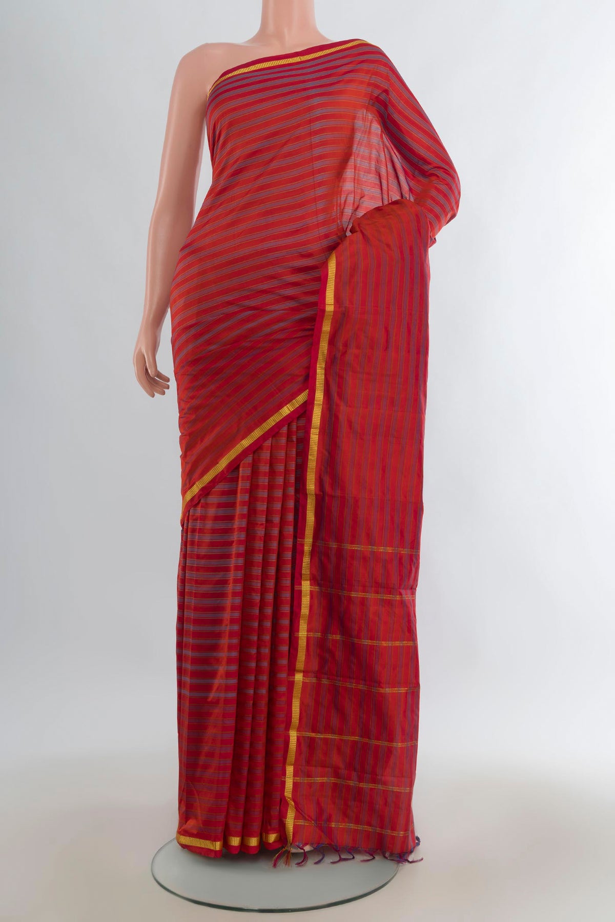Pure Silk Brick Orange Kanchipuram Saree with Stripes on the body and Zari Border.  displayed on a mannequin