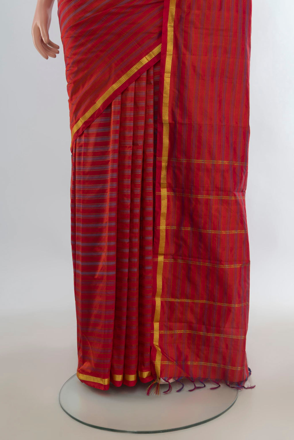 Pleats and pallu of Pure Silk Brick Orange Kanchipuram Saree with Stripes on the body and Zari Border. 