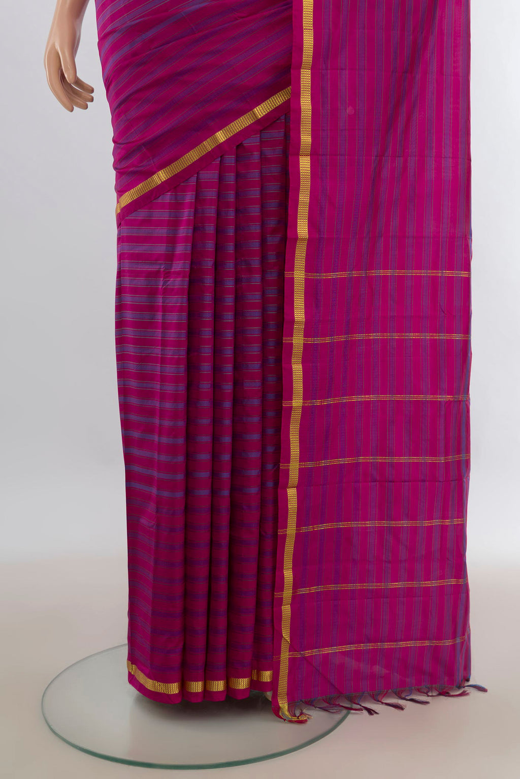 Pleats and pallu of Pure Silk Magenta Kanchipuram Saree with Stripes on the body and Zari Border. 