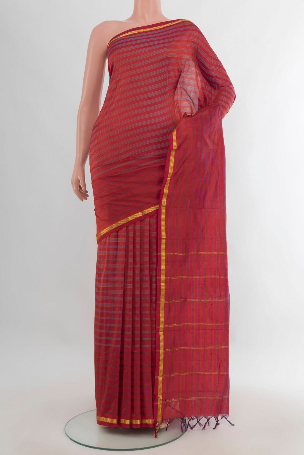 Pure Silk Rust Kanchipuram Saree with Stripes on the body and Zari Border.  displayed on a mannequin