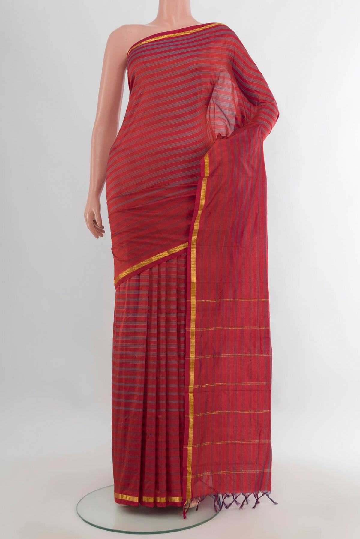 Pure Silk Rust Kanchipuram Saree with Stripes on the body and Zari Border.  displayed on a mannequin