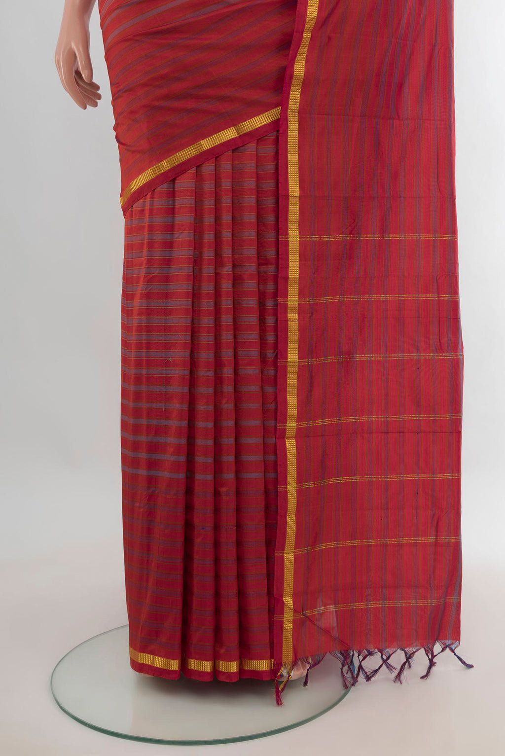 Pleats and pallu of Pure Silk Rust Kanchipuram Saree with Stripes on the body and Zari Border. 