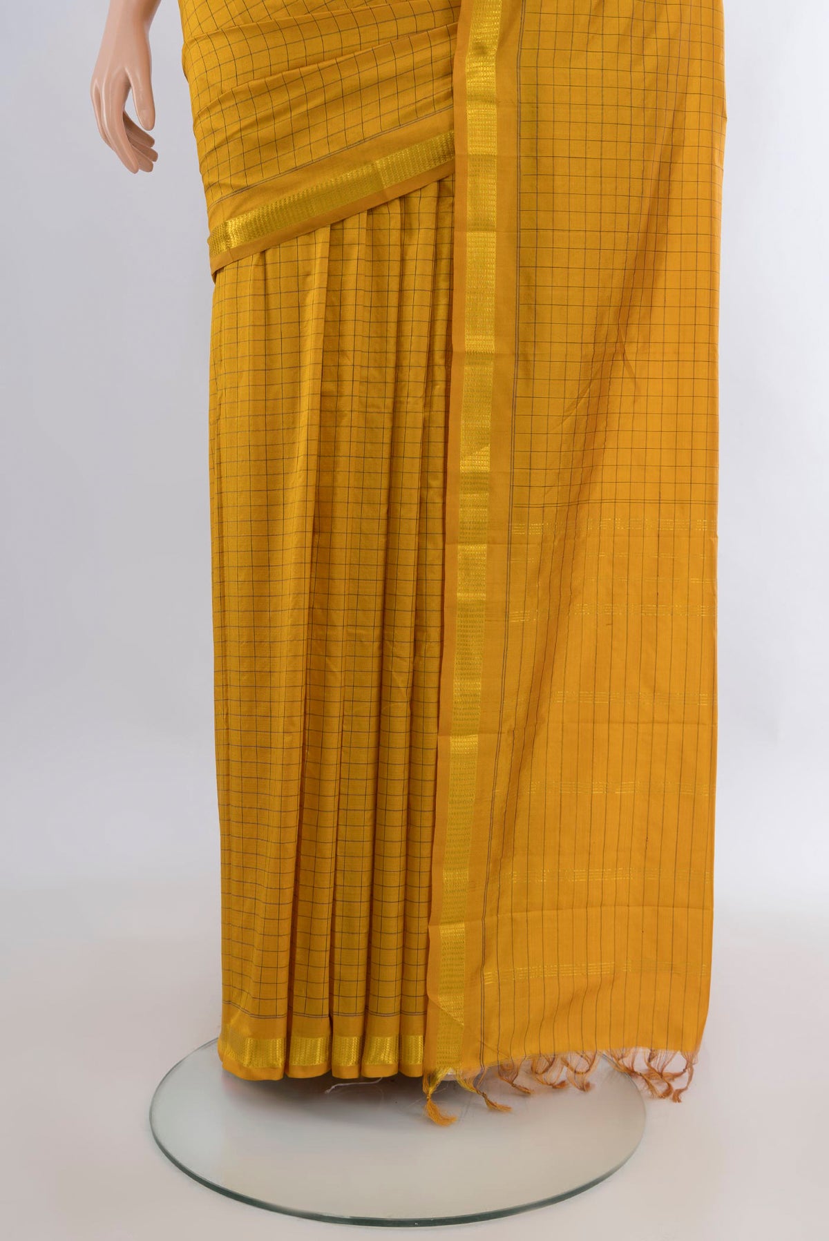 Pleats and pallu of Pure Silk Mustard Kanjivaram Saree with Checked design on the body and Zari Border. 