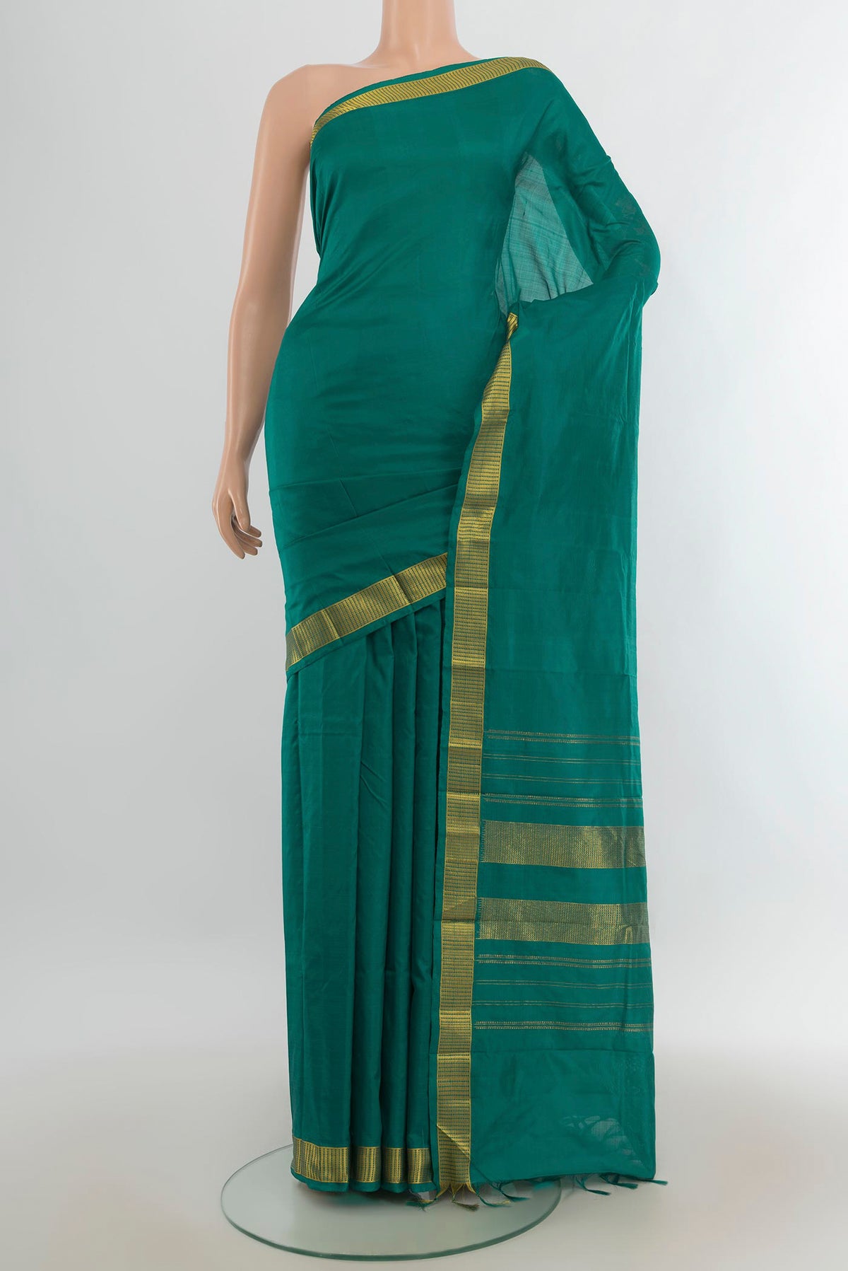 Pure Silk Peacock Blue Kanjivaram Saree with Plain Body and Silk Border.  displayed on a mannequin