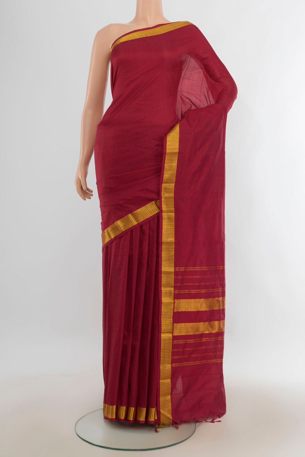 Pure Silk Maroon Kanjivaram Saree with Plain Body and Silk Border.  displayed on a mannequin