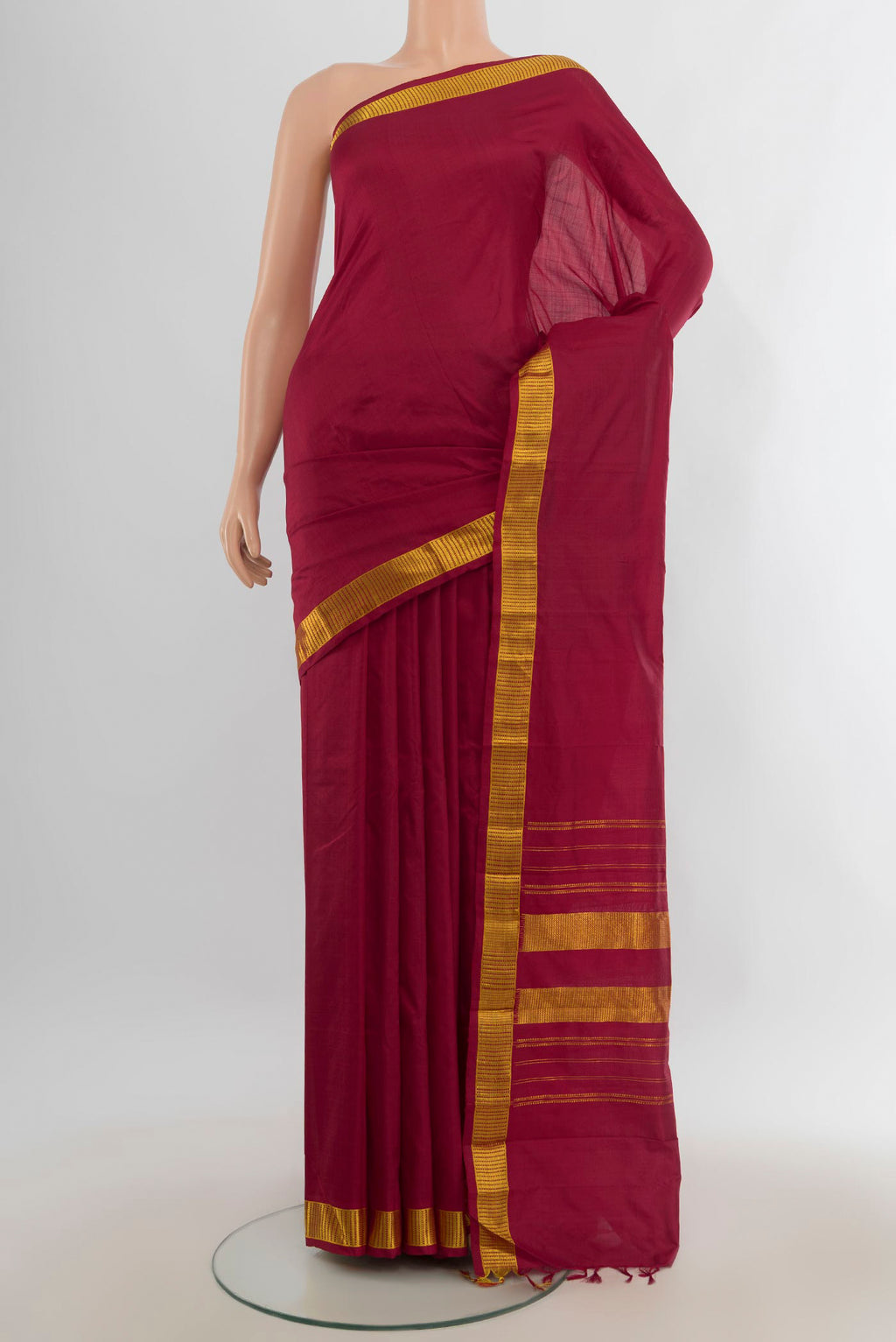 Pure Silk Maroon Kanjivaram Saree with Plain Body and Silk Border.  displayed on a mannequin
