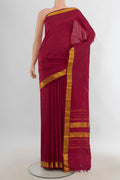 Pure Silk Maroon Kanjivaram Saree with Plain Body and Silk Border.  displayed on a mannequin