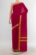 Pure Silk Maroon Kanjivaram Saree with Plain Body and Silk Border.  displayed on a mannequin