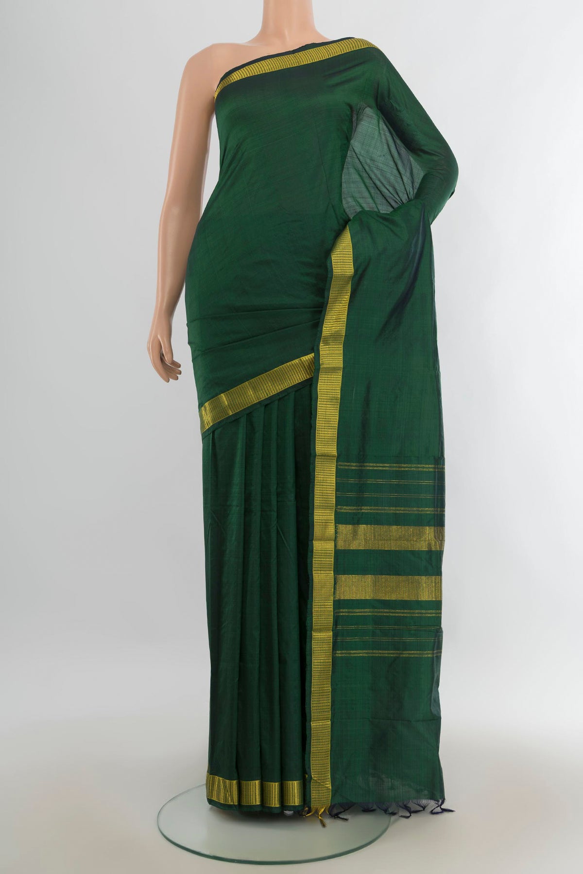 Pure Silk Bottle Green Kanjivaram Saree with Plain Body and Silk Border.  displayed on a mannequin