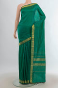Pure Silk Green Kanjivaram Saree with Plain Body and Zari Border.  displayed on a mannequin