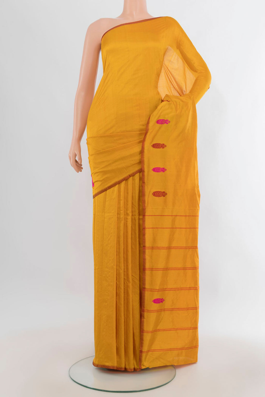 Pure Silk Mustard Kanjivaram Saree with Plain Body and Zari And Thread Border.  displayed on a mannequin