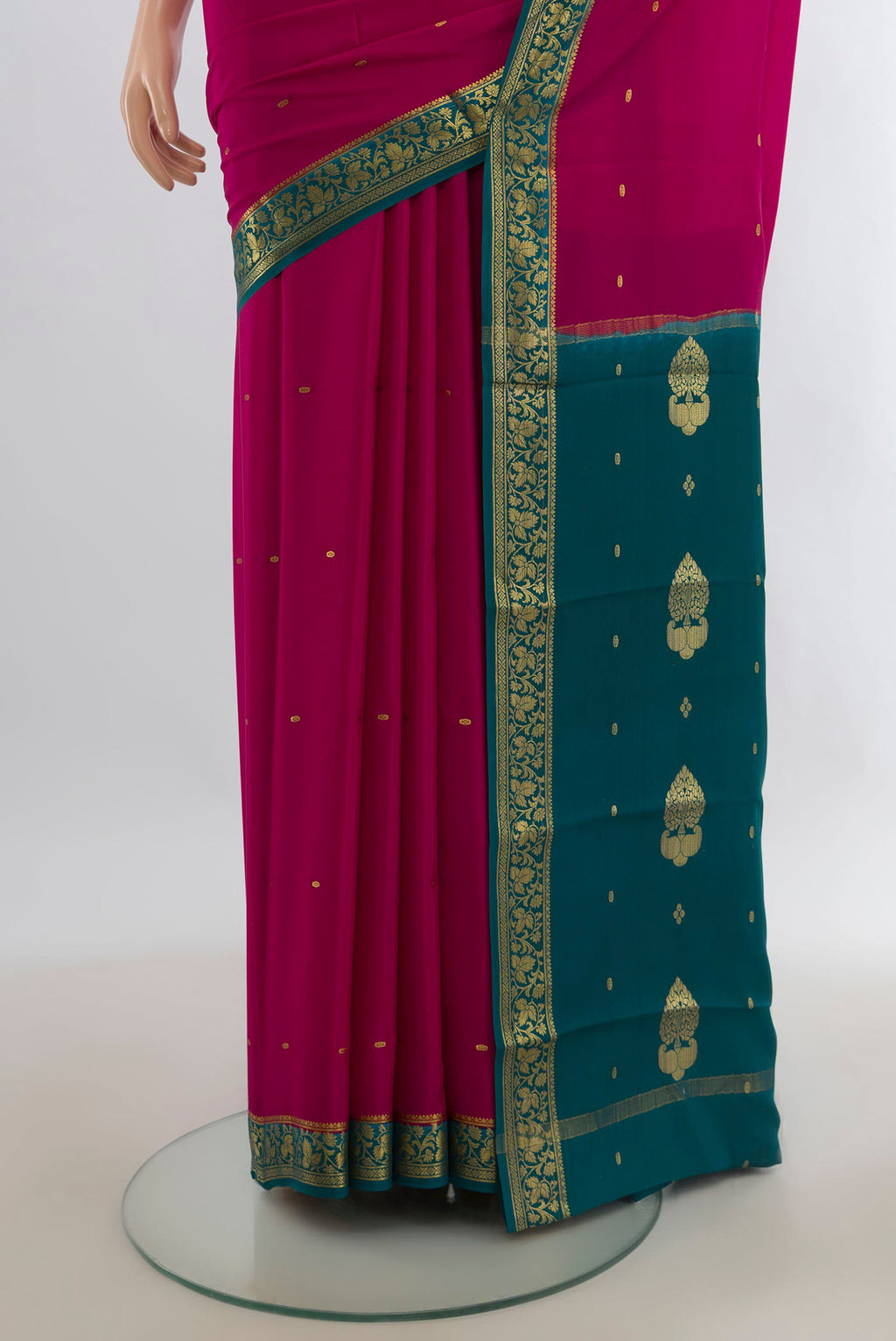 Pleats and pallu of Dark Pink Mysore Crepe Saree with Zari Butta on the body and Zari Border. 
