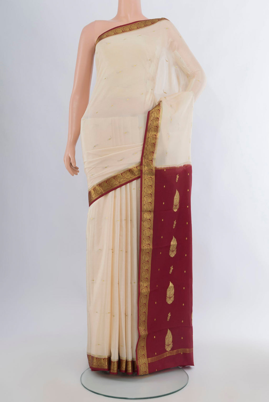 Cream Mysore Crepe Saree with Zari Butta on the body and Zari Border.  displayed on a mannequin