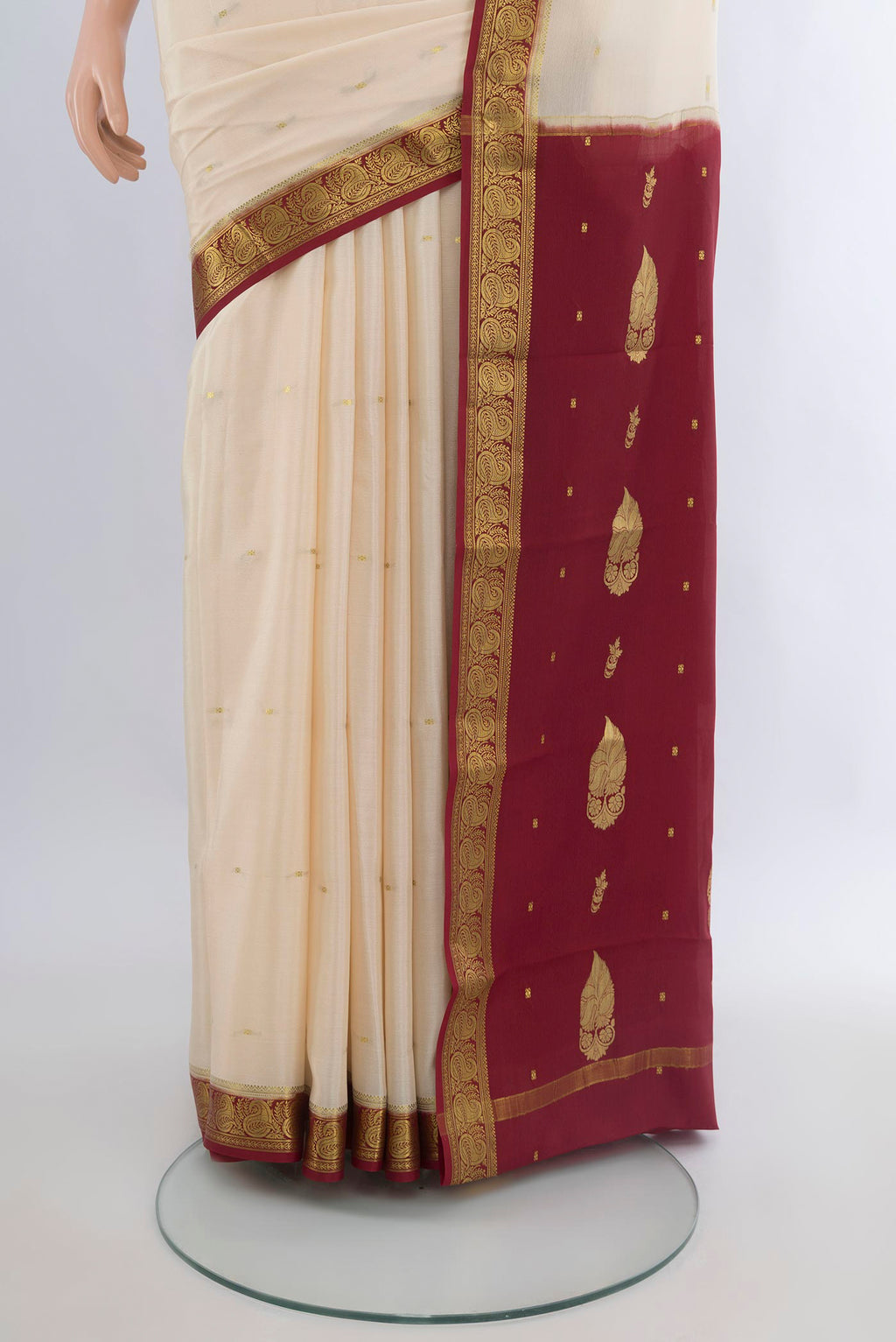 Pleats and pallu of Cream Mysore Crepe Saree with Zari Butta on the body and Zari Border. 