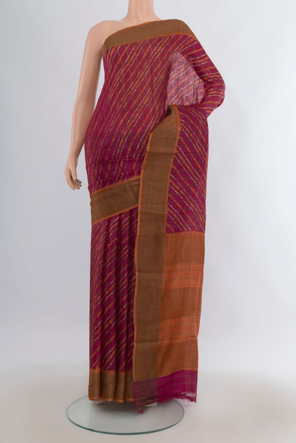 Red Tussar Saree with Floral Print on the body and Zari Border.  displayed on a mannequin