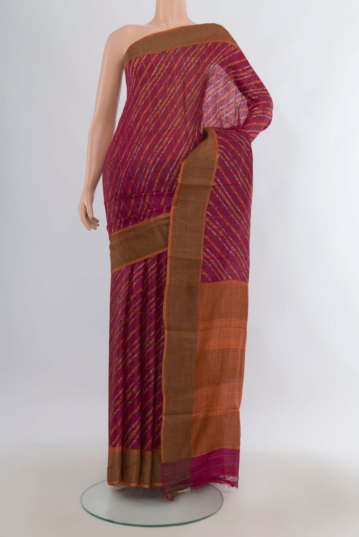 Red Tussar Saree with Floral Print on the body and Zari Border.  displayed on a mannequin