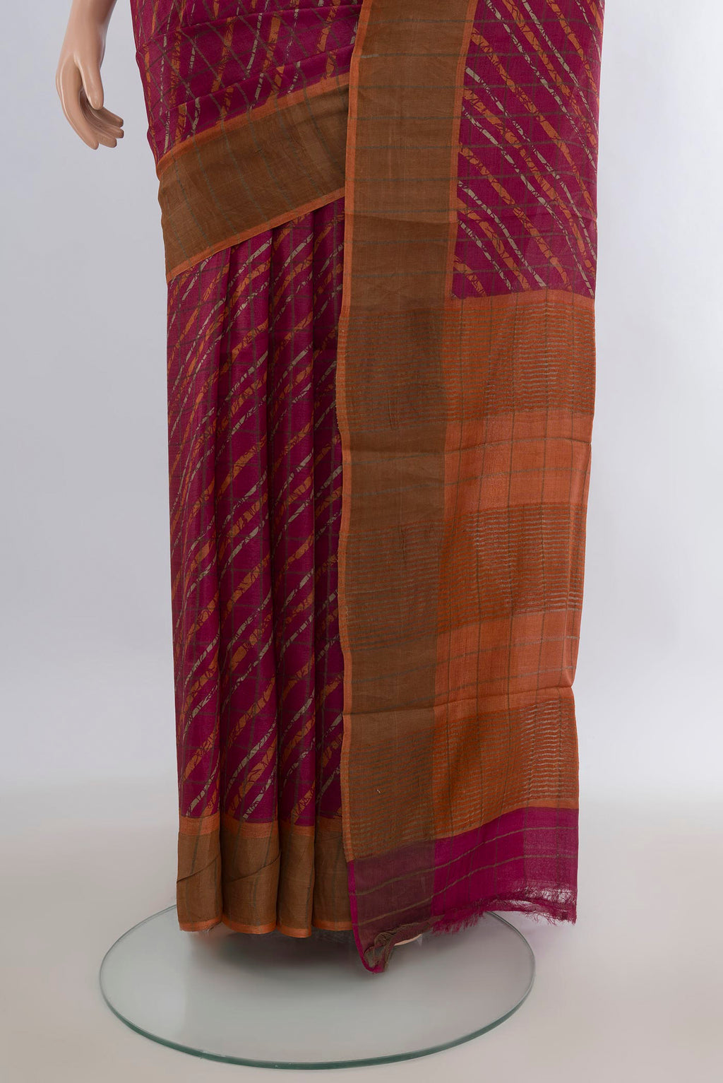 Pleats and pallu of Red Tussar Saree with Floral Print on the body and Zari Border. 