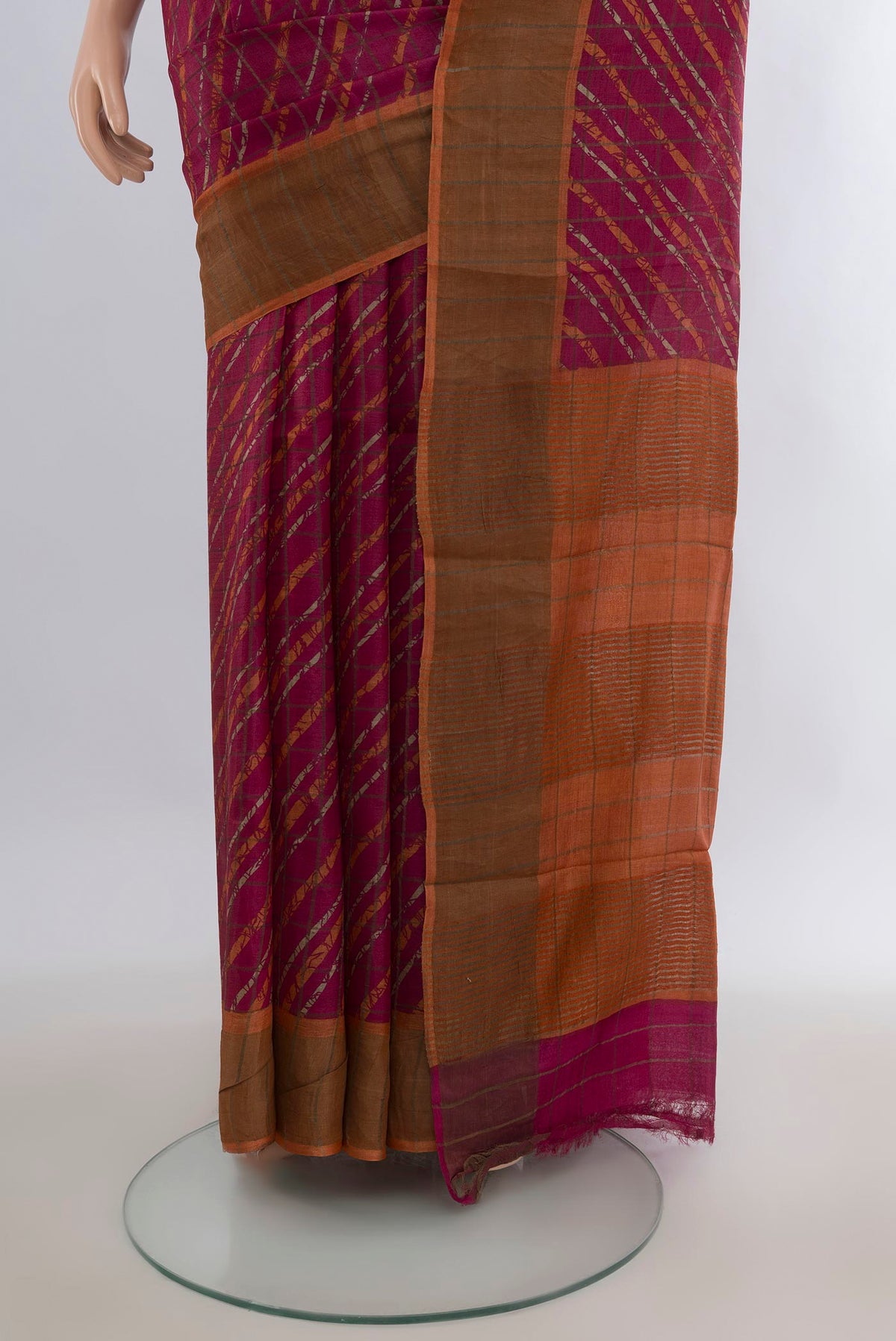 Pleats and pallu of Red Tussar Saree with Floral Print on the body and Zari Border. 