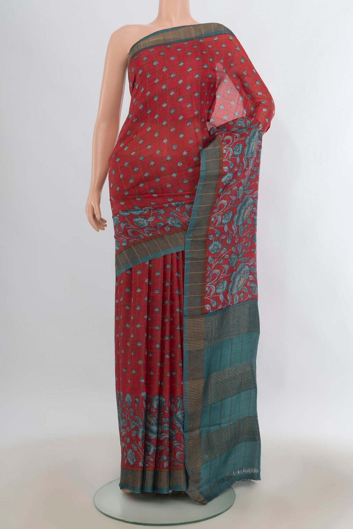Red Tussar Saree with Printed design on the body and Zari And Thread Border.  displayed on a mannequin