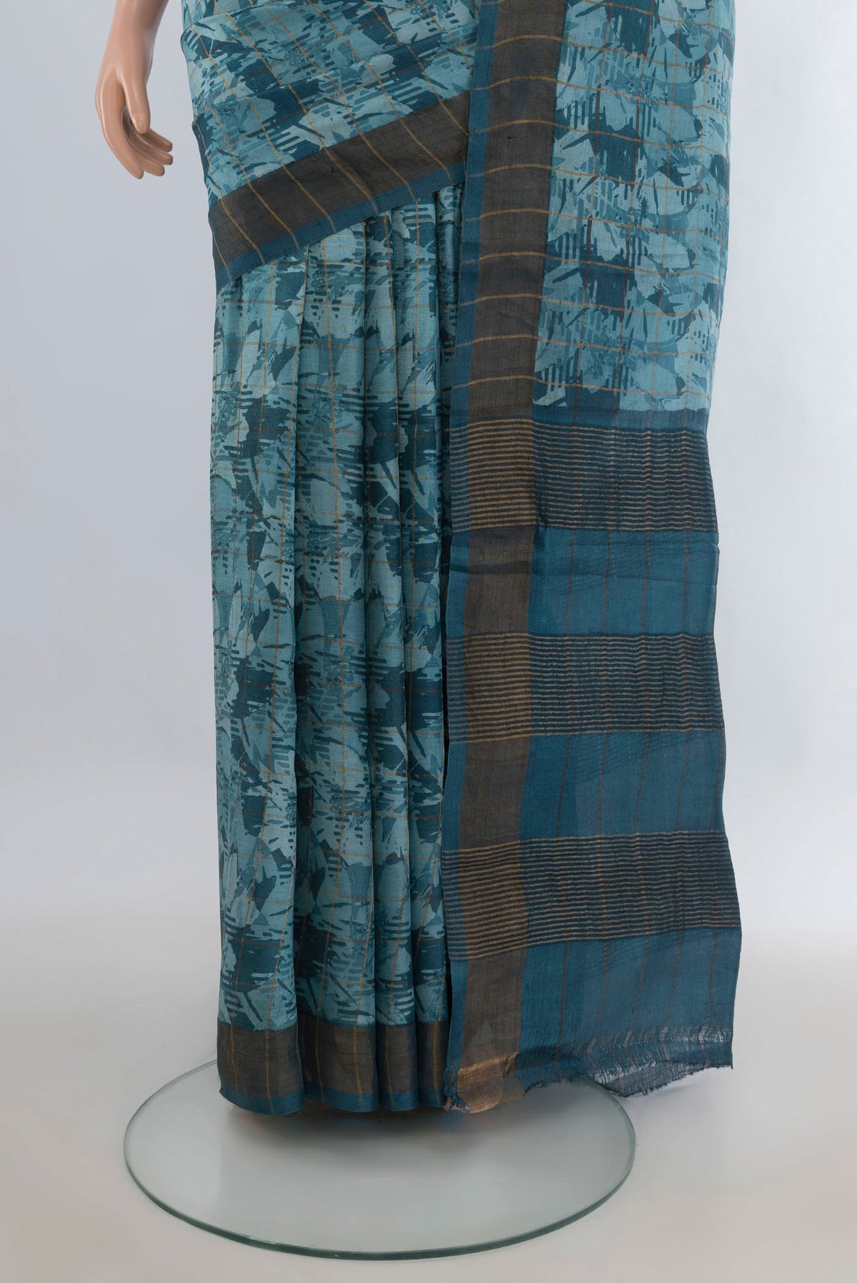 Pleats and pallu of Teal Tussar Saree with Floral Print on the body and Zari Border. 