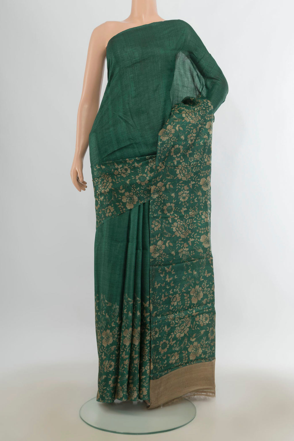 Bottle Green Tussar Saree with Plain Body and Without Border.  displayed on a mannequin