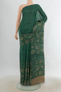 Bottle Green Tussar Saree with Plain Body and Without Border.  displayed on a mannequin