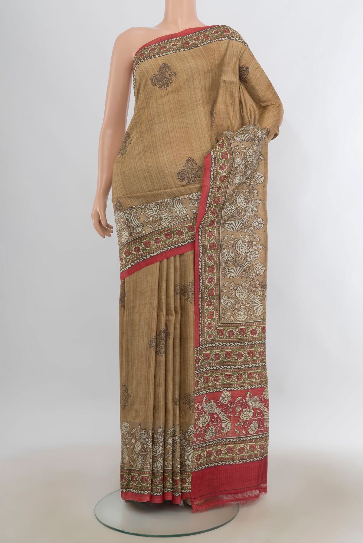Beige Tussar Saree with Printed design on the body and Printed Border.  displayed on a mannequin
