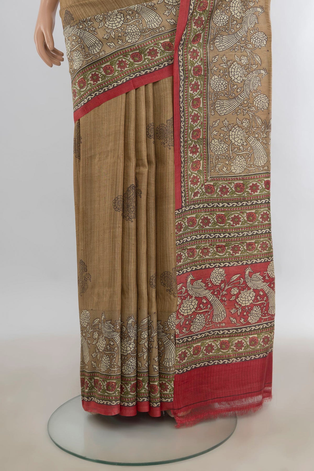 Pleats and pallu of Beige Tussar Saree with Printed design on the body and Printed Border. 