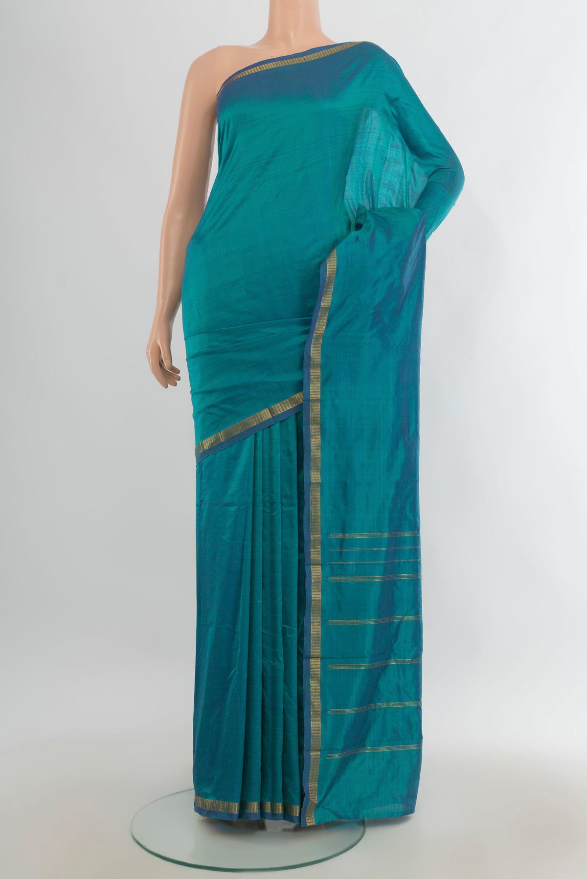 Pure Silk Peacock Blue Kanchipuram Saree with Plain Body and Silk Border.  displayed on a mannequin